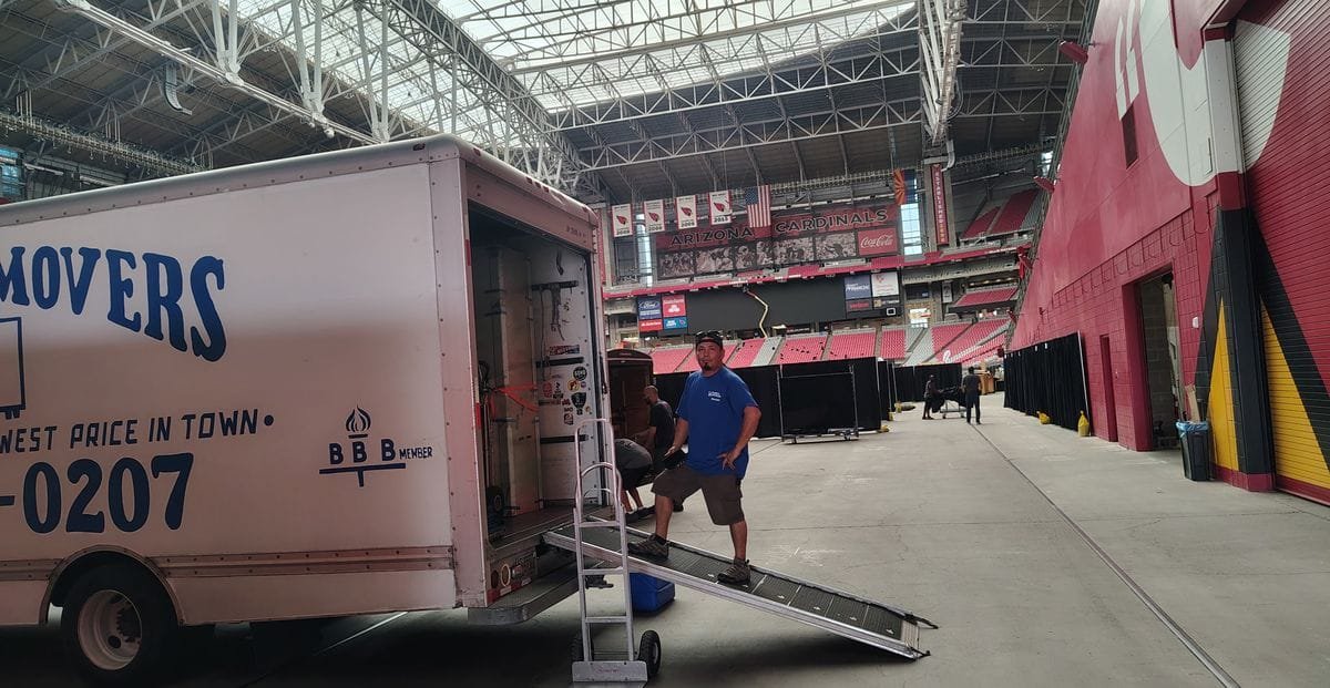 A Garcia mover on the truck's loading ramp inside State Farm Stadium