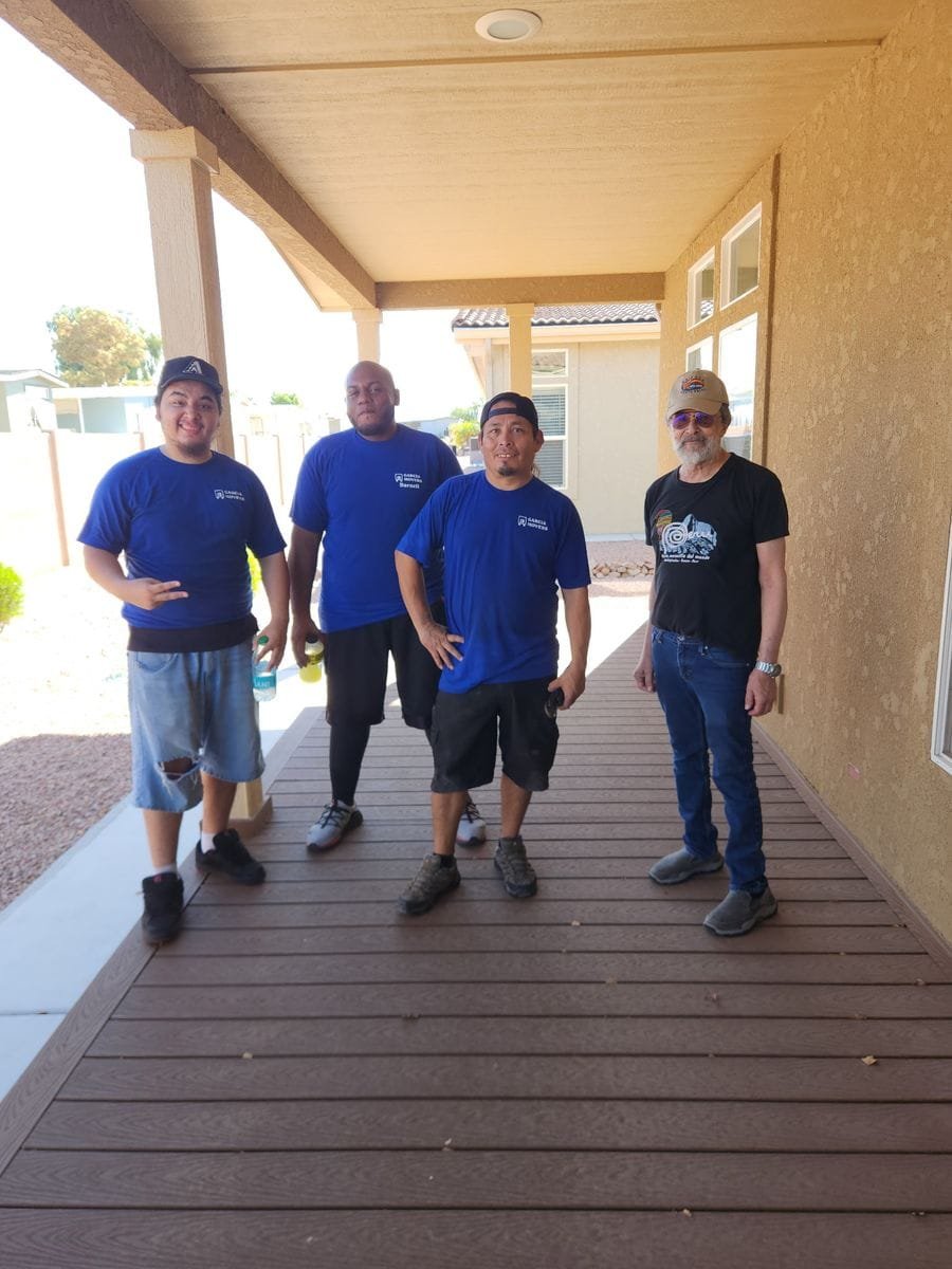 Members of the Garcia Movers team together on a covered porch